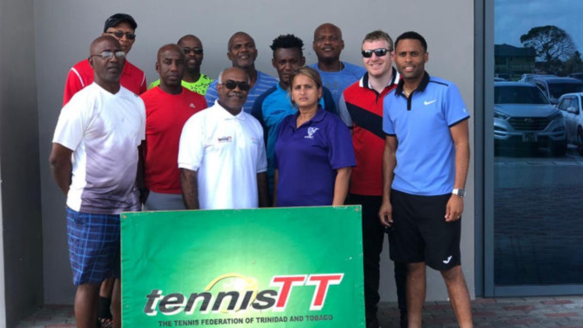 Tennis coach education group with the tennisTT sign